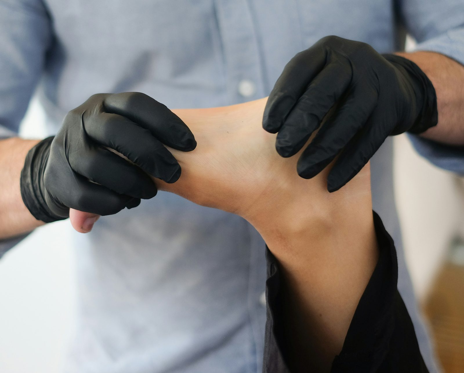 Person receiving plantar fasciitis treatment for heel and arch pain — High Amplitude Health San Mateo